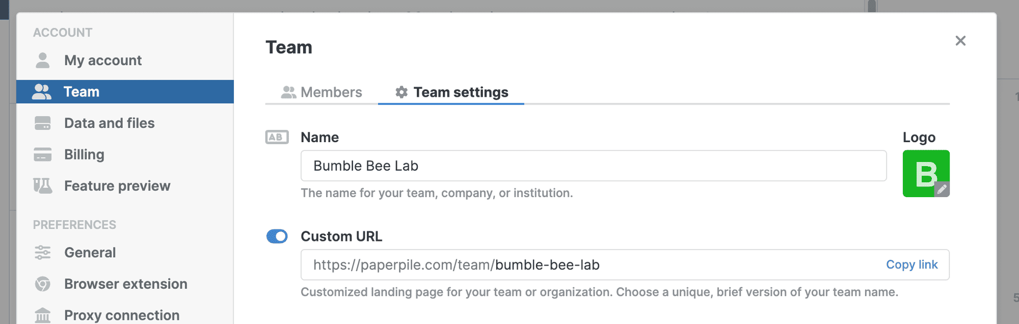 Settings › Team on the Team settings tab, with a Name field reading “Bumble Bee Lab”, an editable logo, and a Custom URL toggle switched on showing the team’s branded landing-page address and a “Copy link” action.